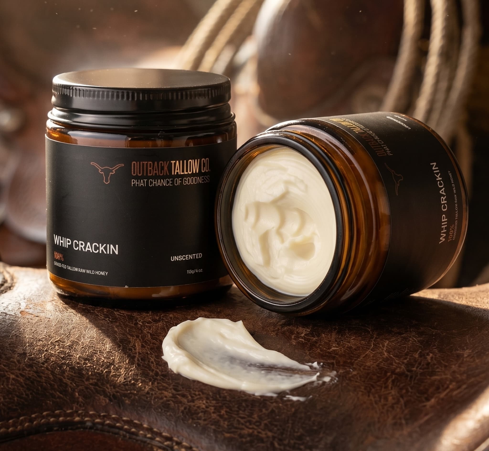 Outback Tallow Co Whip Crackin whipped tallow balm jar on leather surface