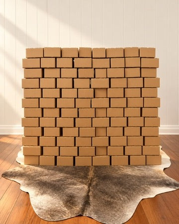 Stack of Outback Tallow Co orders packed by hand in shipping boxes, ready to send