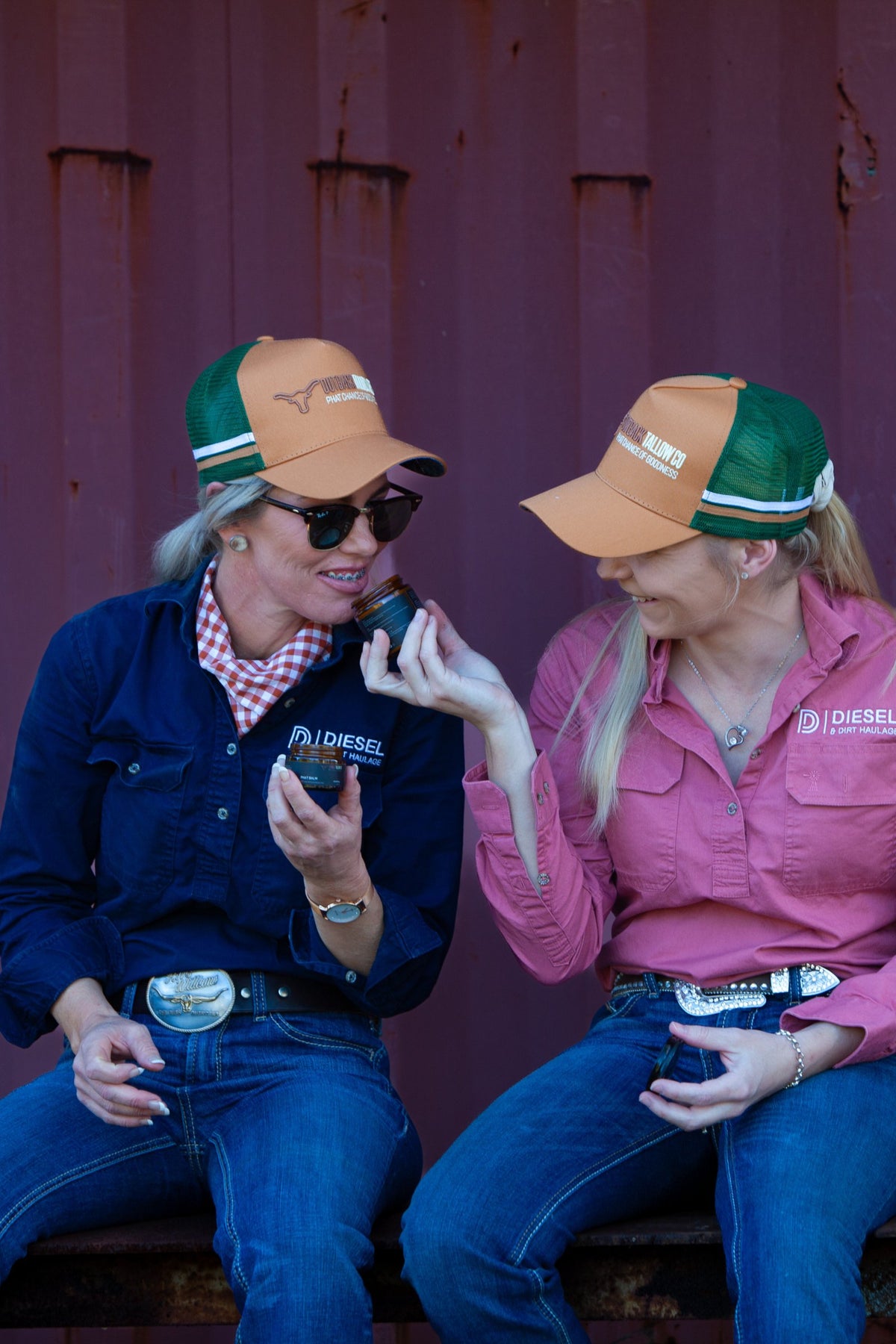 Kylie and Kimmy sharing a jar of Outback Tallow Co tallow balm outside the shed