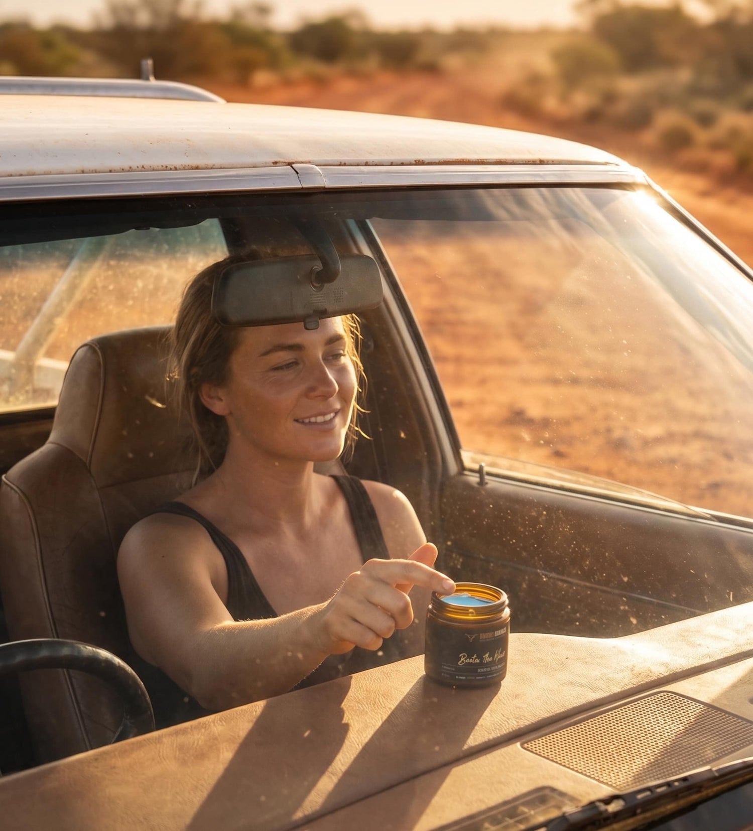 Woman in outback Australia ute holding Bootin the Blues grass-fed beef tallow balm for sensitive skin eczema psoriasis and rosacea golden sunset red dirt background natural skincare no synthetic fragrance fast shipping Australia wide – Outback Tallow Co Townsville Queensland Australia