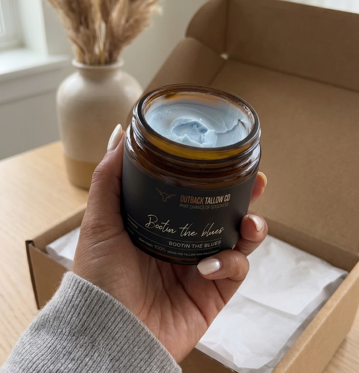 Bootin the Blues whipped blue tansy grass-fed beef tallow balm for sensitive skin eczema psoriasis and rosacea held in hand showing blue texture with cosy home unboxing feel natural skincare no synthetic fragrance fast shipping Australia wide – Outback Tallow Co Townsville Queensland Australia