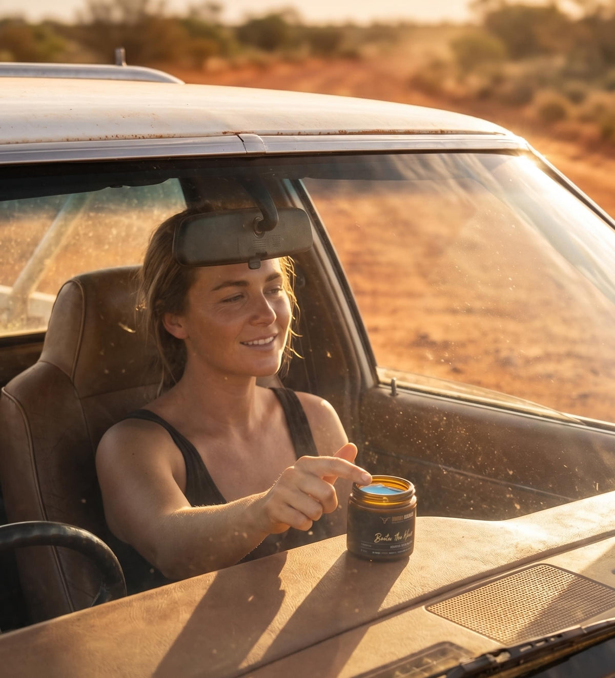 Woman in a ute holding Bootin&