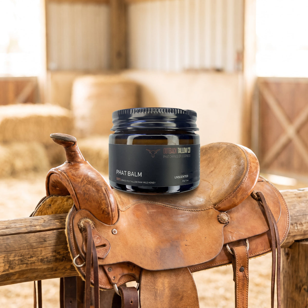 PHAT Balm jar sitting on a western saddle in a hay shed (AI-generated image)