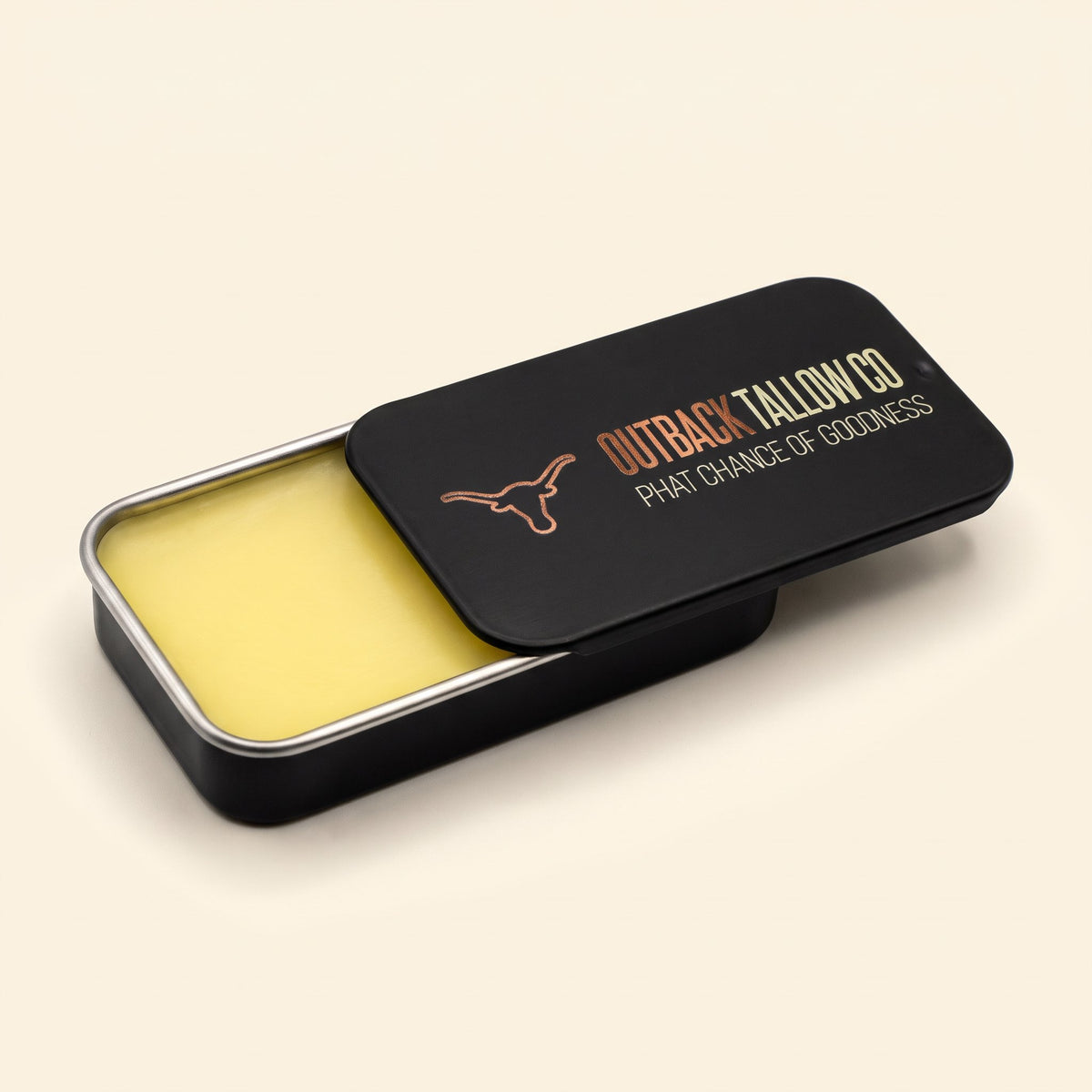 The OG slide tin open wide, showing the smooth pale yellow tallow balm (AI-generated image)