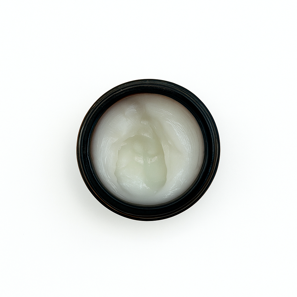Small black jar with phat balm on a white background